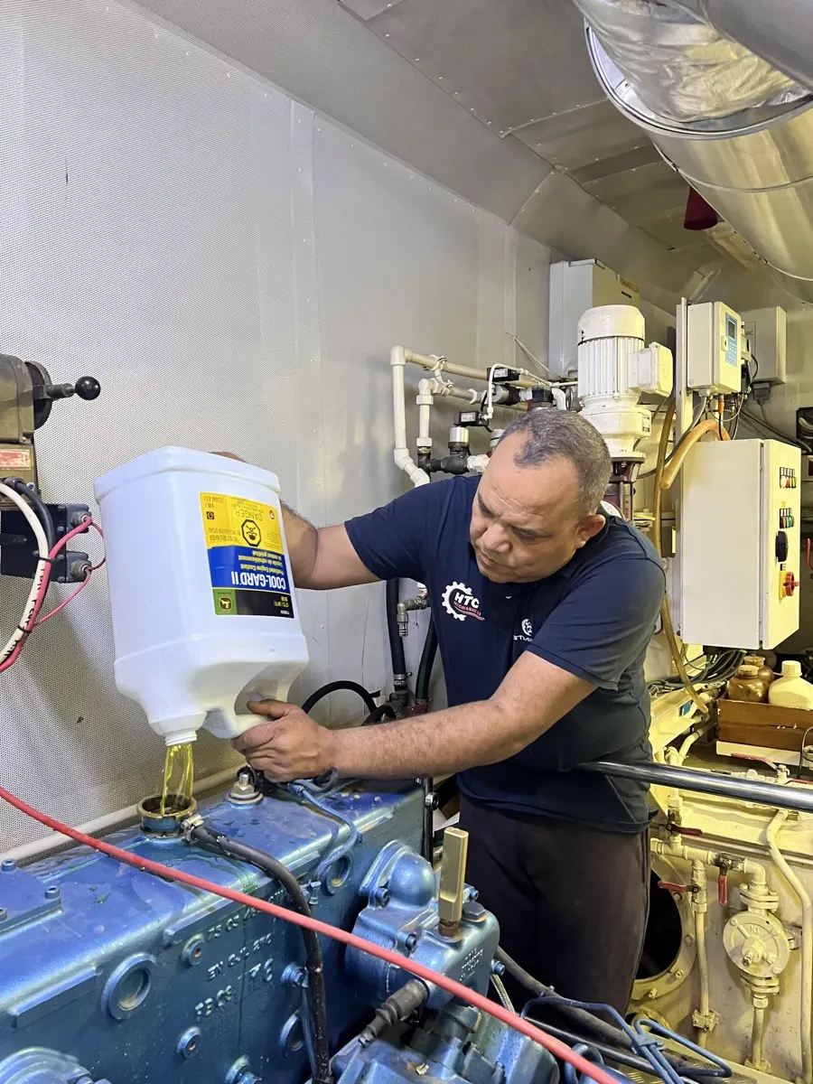 HTC Mechanic marine mechanic checking a diesel marine engine in the engine room